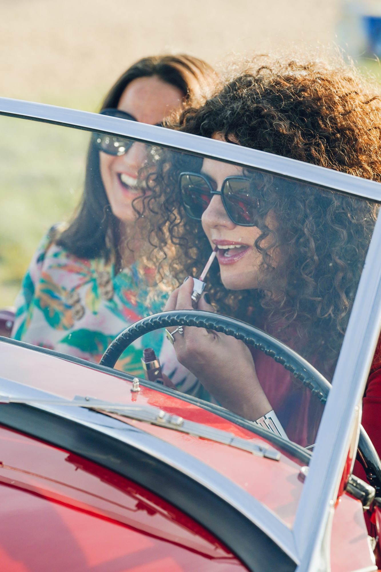 Guests in a convertible on the coast